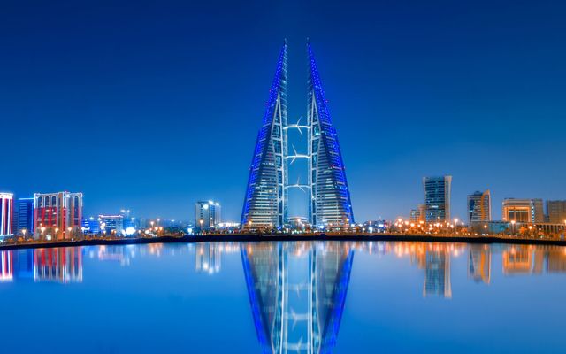 Bahrain’s financial towers reflected in the bay at dusk