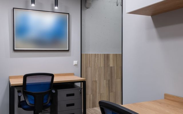 Rows of clean modern workstations in a bright corporate office
