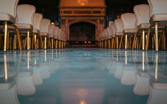 A clean, elegant event hall with arranged seating and lighting