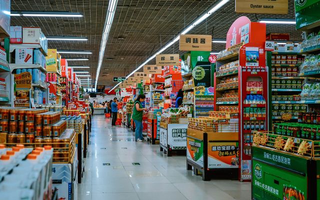 A clean, bright supermarket aisle with stocked shelves