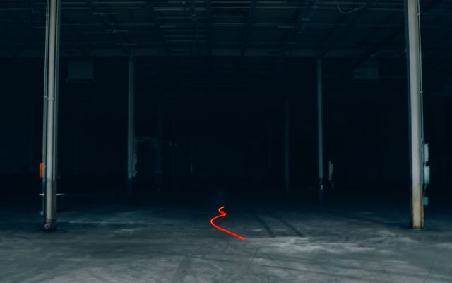 A clean, empty warehouse floor with racking and natural light
