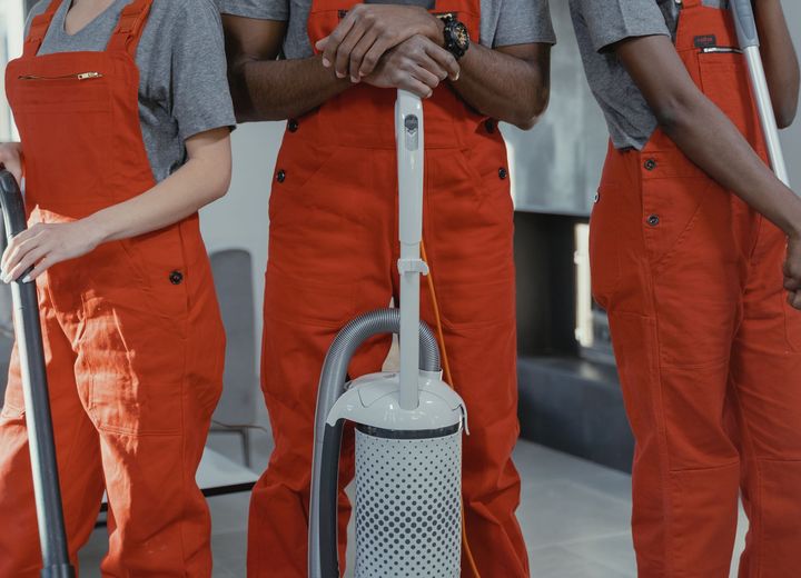 Members of the Magic Ring cleaning team in matching work coveralls
